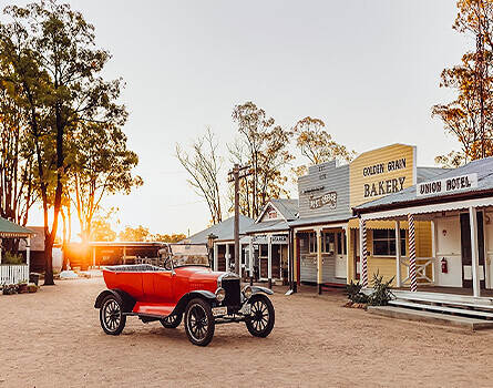 Museum at dusk with old car in foreground