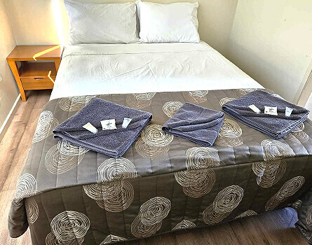 Bed with towels and extra bedding and linen among other great cabin features